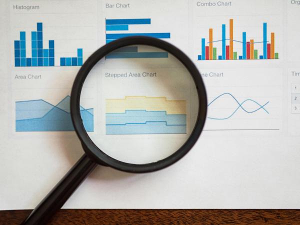 A Magnifying Glass on a Page of Various Charts